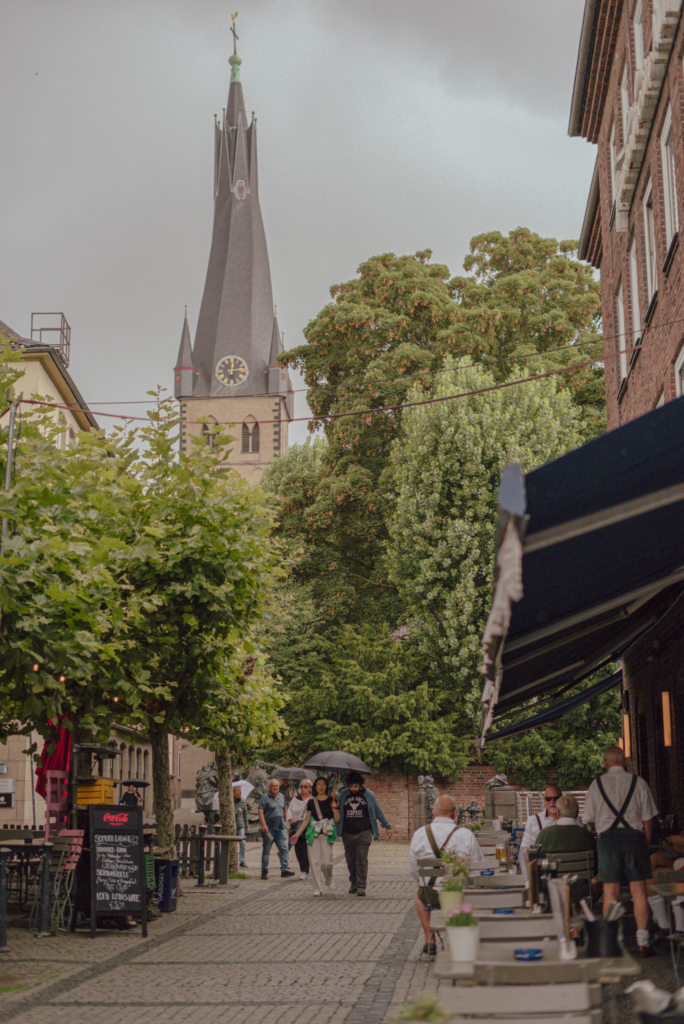 Altstadt Dusseldorf read brick buildings and chruch towers with greenery