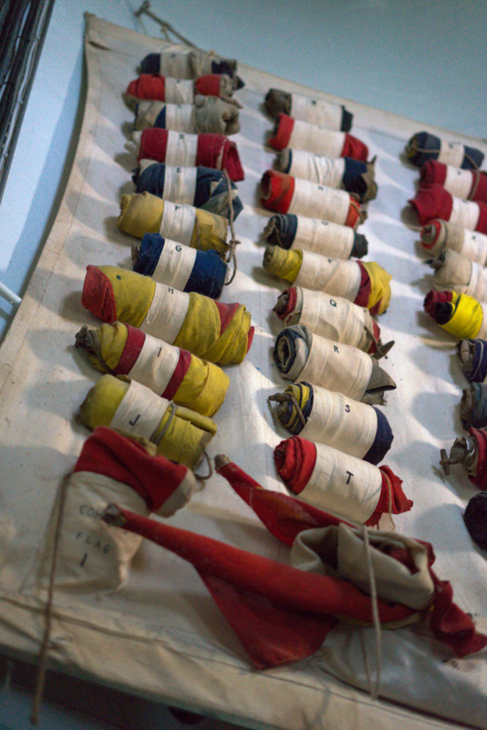 various flags are rolled up on a wall inside the fanad lighthouse in Donegal, Ireland