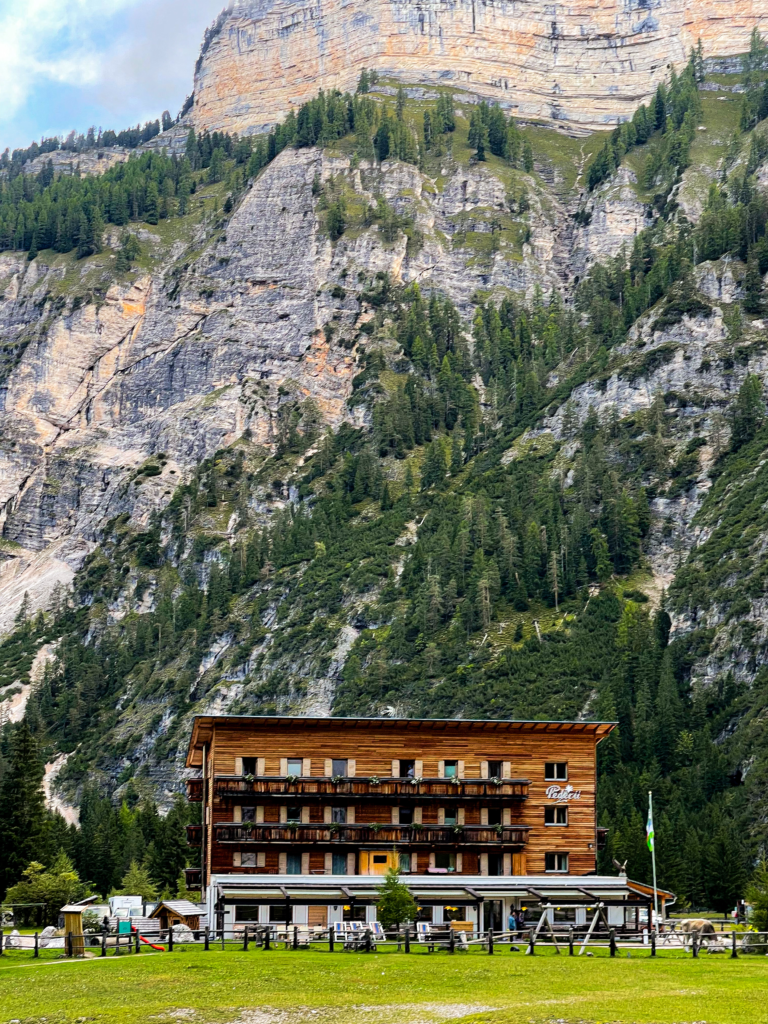 View of Rifugio Pederu on the Alta Via 1 with an alpine view in the back