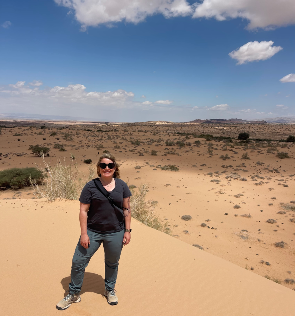 Woman standing on sand dune in the deadsea
