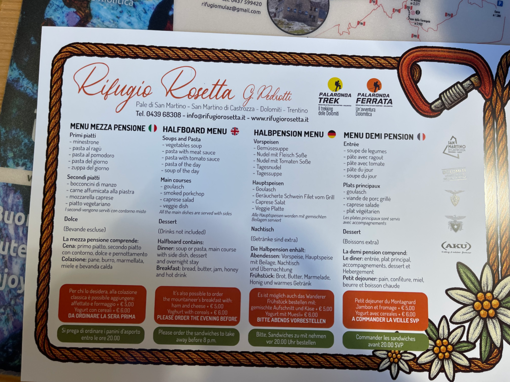 Menu at Rifugio Rosetta with food items in small print in different languages