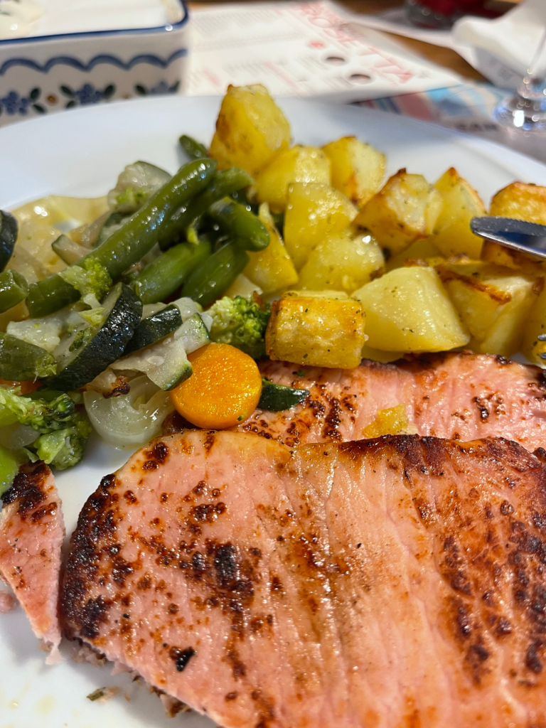 seared pork with potatoes and green beans on a white plate day 3 at Rifugio Treviso