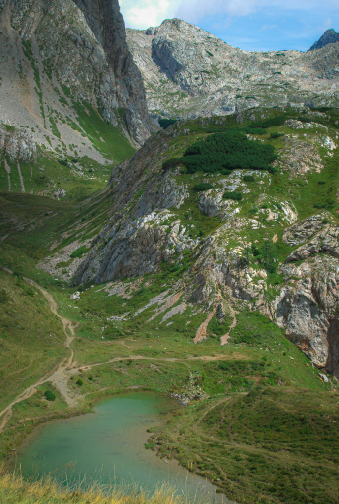 Lago pera with its green waters and stunning mountain setting