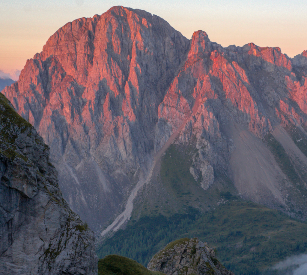 Purple orange Sunrise on a mountainside in the italian friulian dolomites from Rifugio Calvi