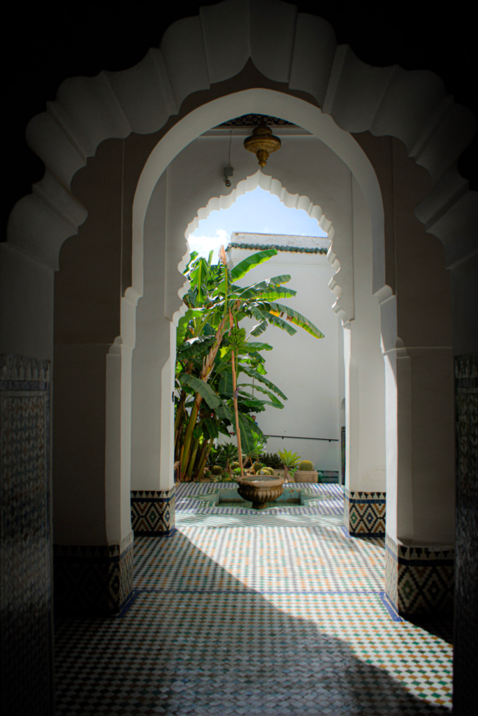 A doorway shaded with the sun shining through in Meknes at the music museum