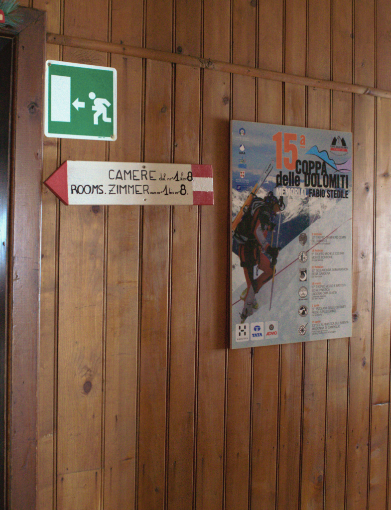 Sign hanging on a wall with room numbers at Rifugio Rosetta on the Pale di San Martino