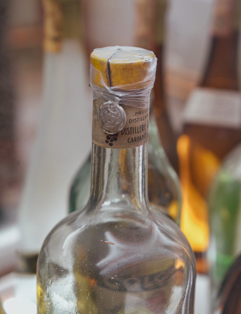 The top of a an old bottle with a tiny tax medal on top