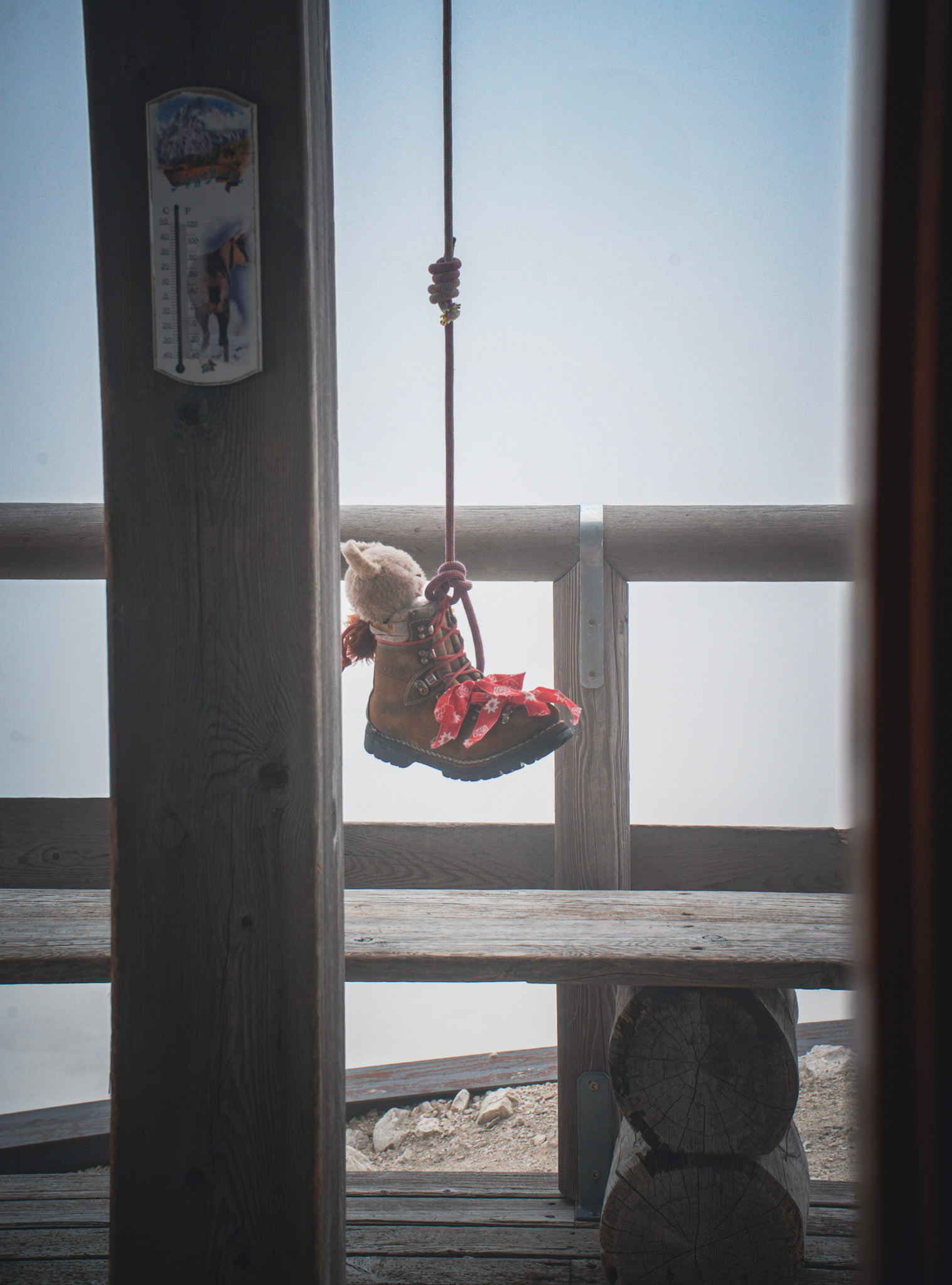 Palaronda Trek Rifugio Rosetta boot hanging from doorway with bear in it outside of Rifugio Rosetta