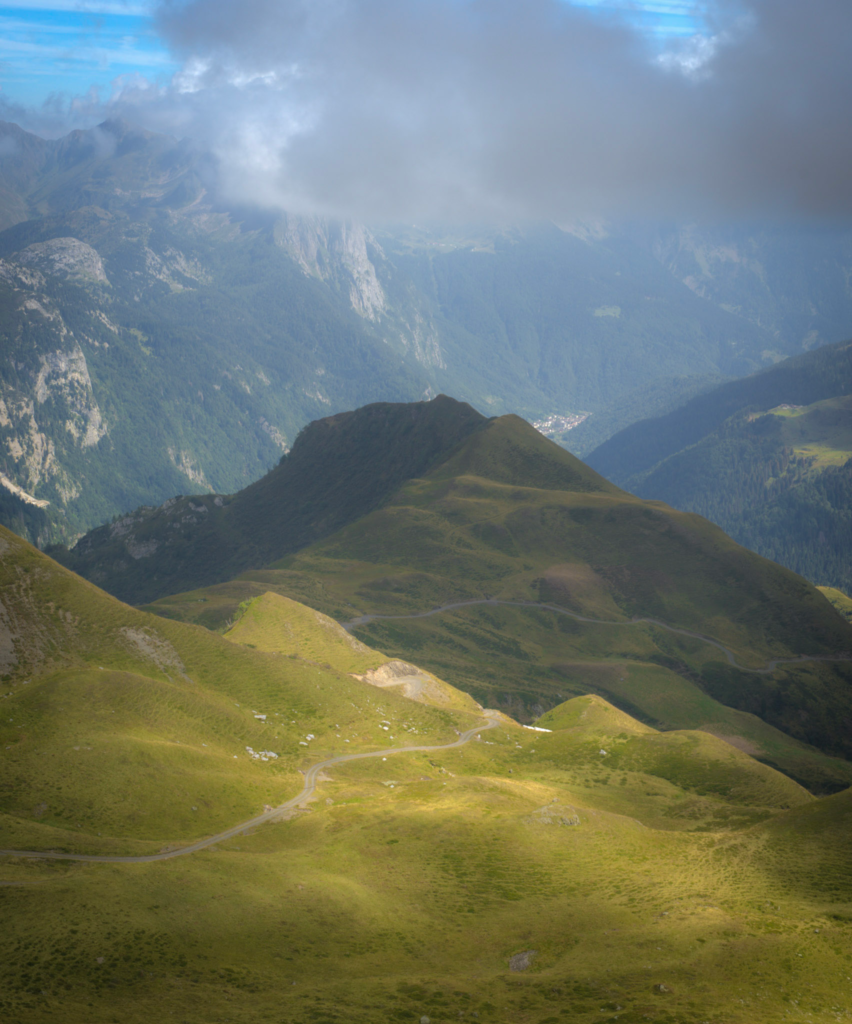 a vast valley with green sunlight shining down on it from Rifugio Marinelli