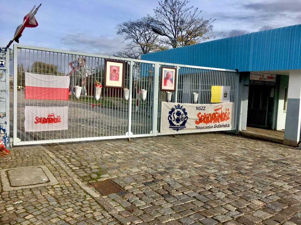 Entrance to the Gdansk shipyard with signs saying Solidarnosc and various polish banners