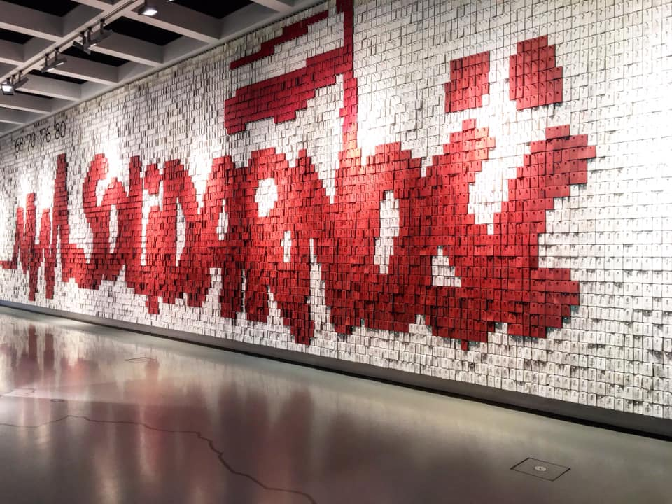 a dramatic wall with white and red writing at the Solidarity Museum in Gdansk Poland made with post it notes