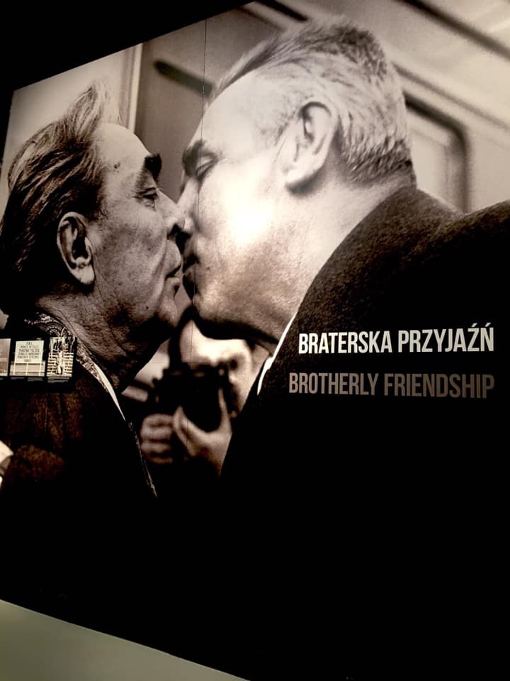 a photograph of two me kissing on the lips at the European Solidarity center