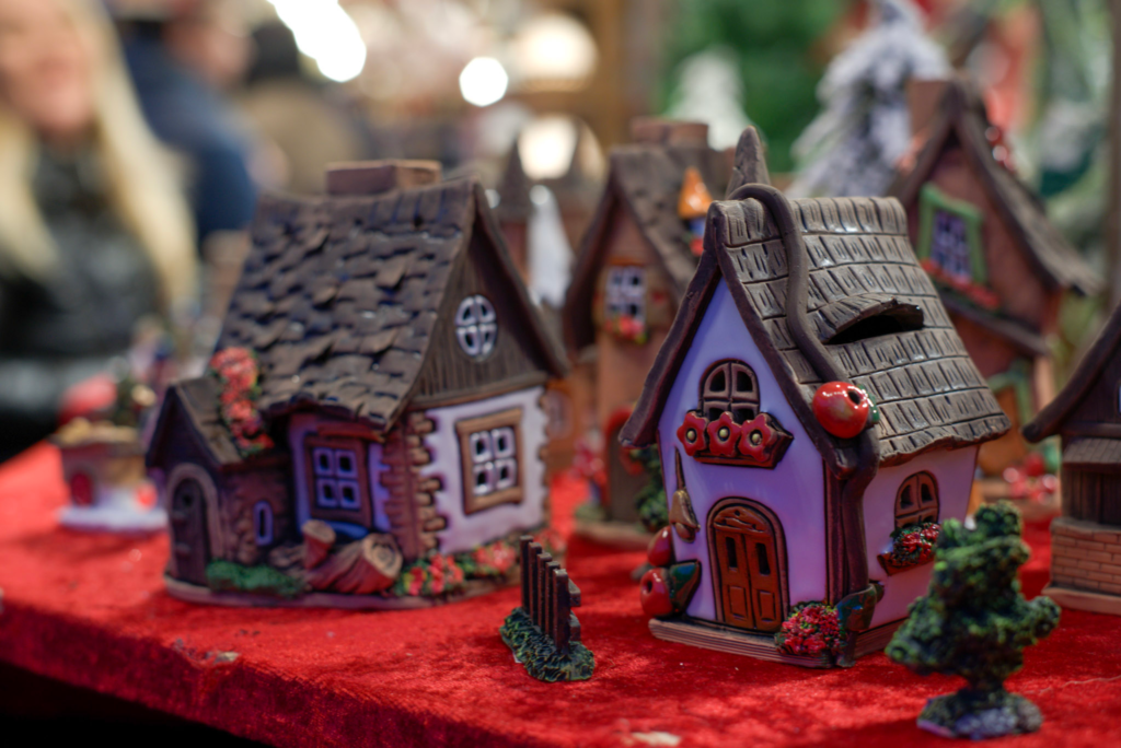 two little chalet smokers for sale at the Verona Christmas Market that are decorated like winter time chalets in the mountains