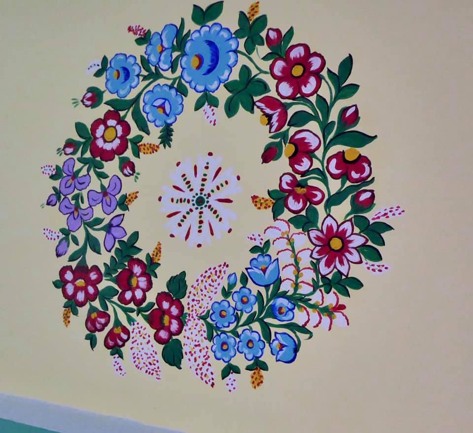 blue and pink flowers on a white wall in the most beautiful village in Poland , Zalipie