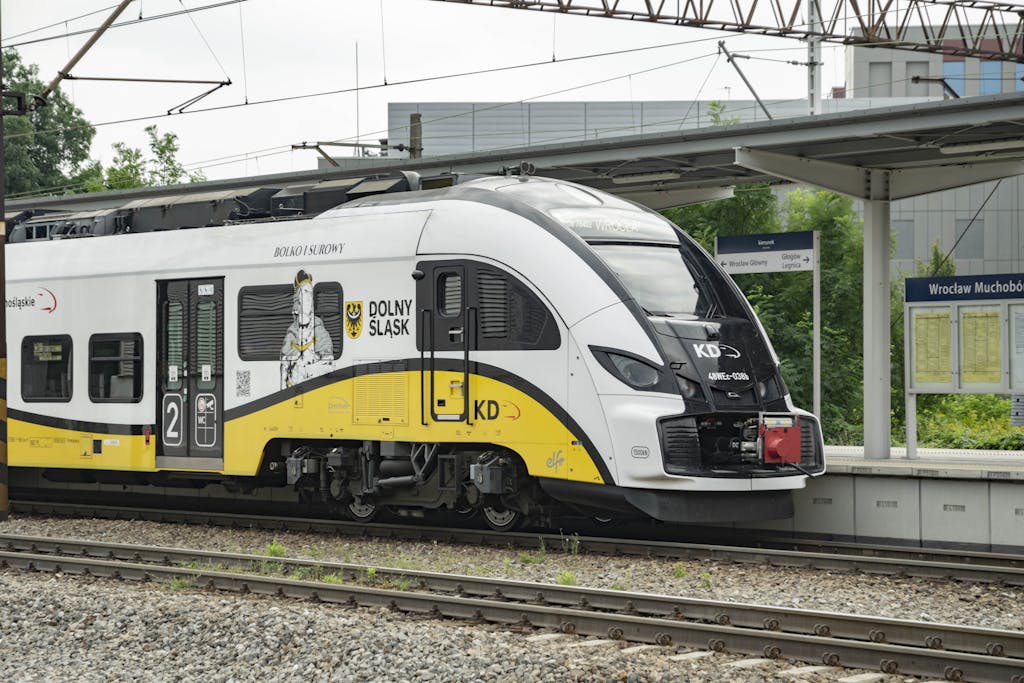 A sleek train at Wrocław Muchobór station representing Polish public transport.