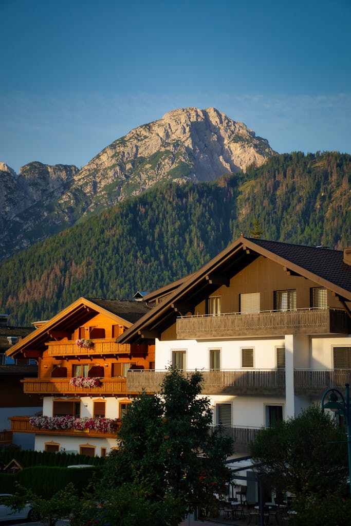 Picturesque alpine village scene with traditional houses and mountain backdrop in Toblach, Italy.