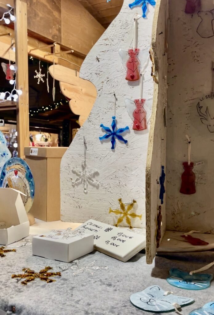 glass ornaments on display in the shape of snowflakes on sale at the Marche Vert Noel in Aosta