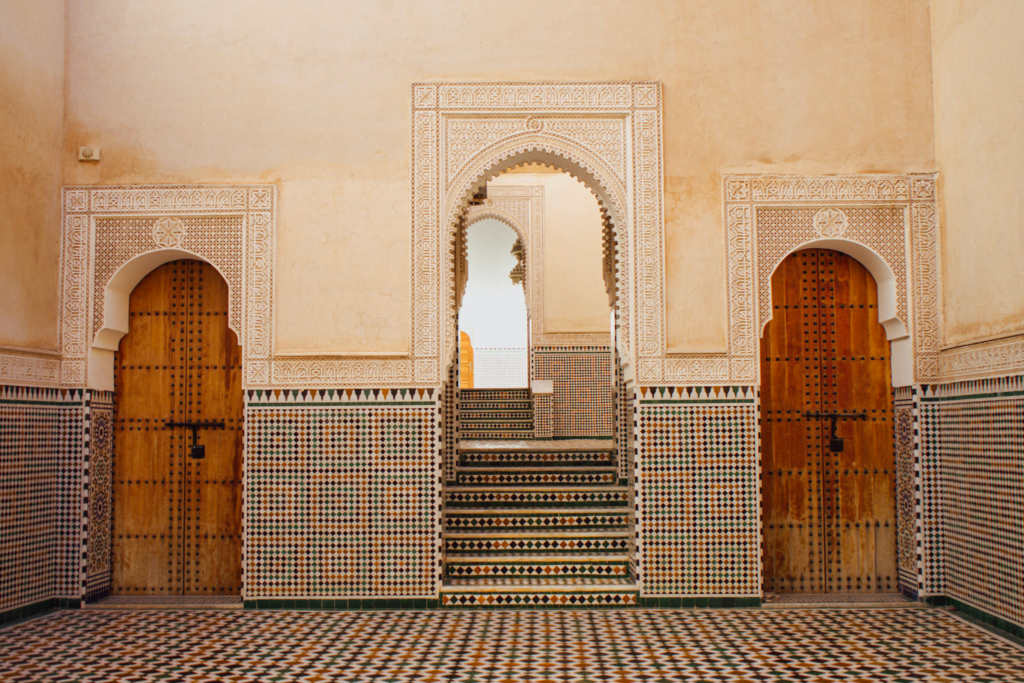 two wooden doors in a room with zelige tiles in Meknes Morocco