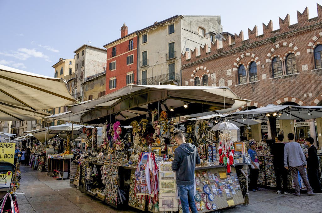 Lively street market scene in Verona, showcasing local crafts and architecture.