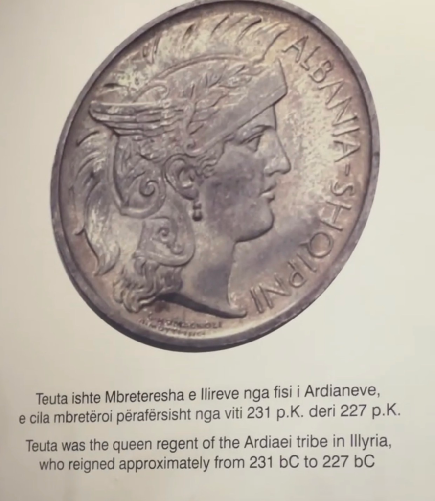 Photograph of a coin featuring Queen Teuta of Illyria in profile with the inscription Albana Shqiptar. The caption below explains that Teuta ruled the Ardiaei tribe from 231 BC to 227 BC.