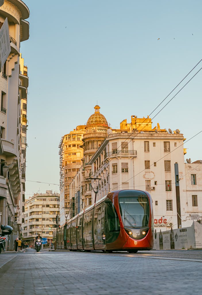 A modern tram navigating the streets of Casablanca, Morocco against a backdrop of historic architecture.