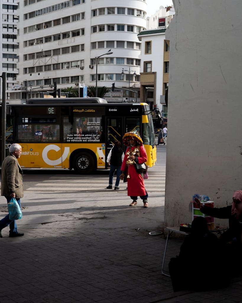 Busy Casablanca street capturing traditional water seller and city life ambiance.