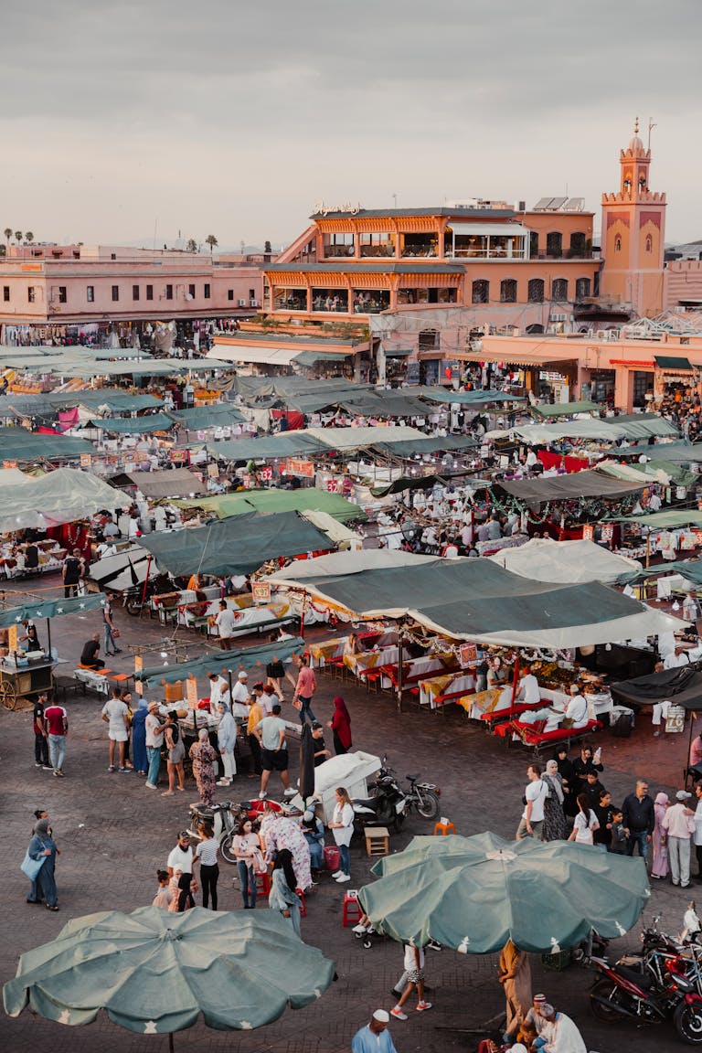 Aerial view of iconic Jemaa el-Fnaa Market in Marrakesh bustling with activity and vibrant stalls.