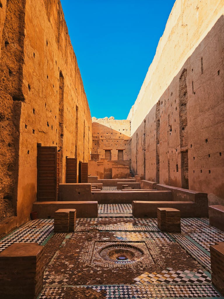 Historic Moroccan architecture under clear blue sky in Marrakech.
