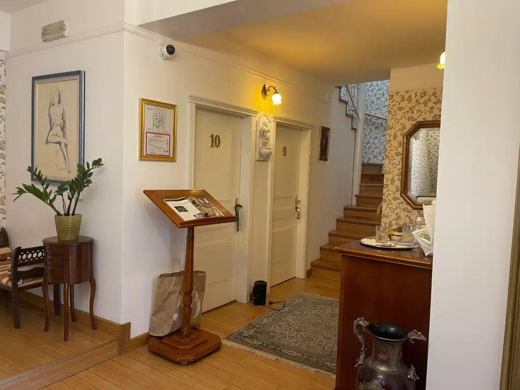 Allegro Hotel Ljubljana interior hallway with vintage decor, floral wallpaper, and guest room doors in old town