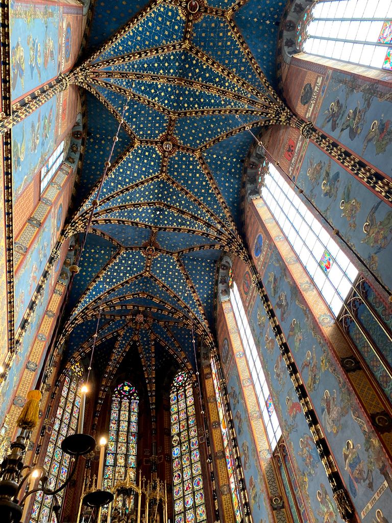 Explore the breathtaking blue ceiling and stained glass in St. Mary's Basilica, Kraków.