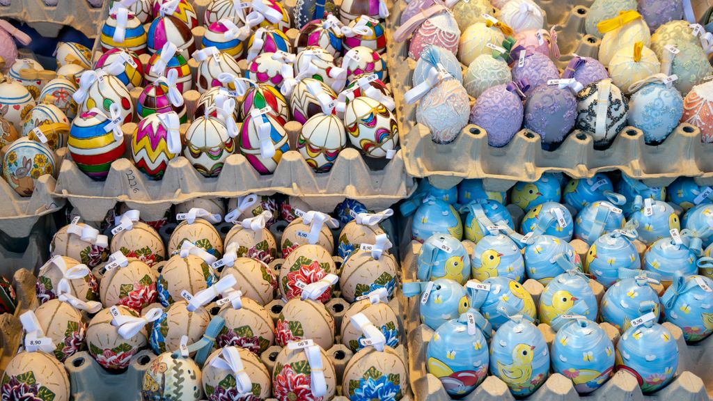 Vibrant decorative Easter eggs on display at a market, showcasing various designs.