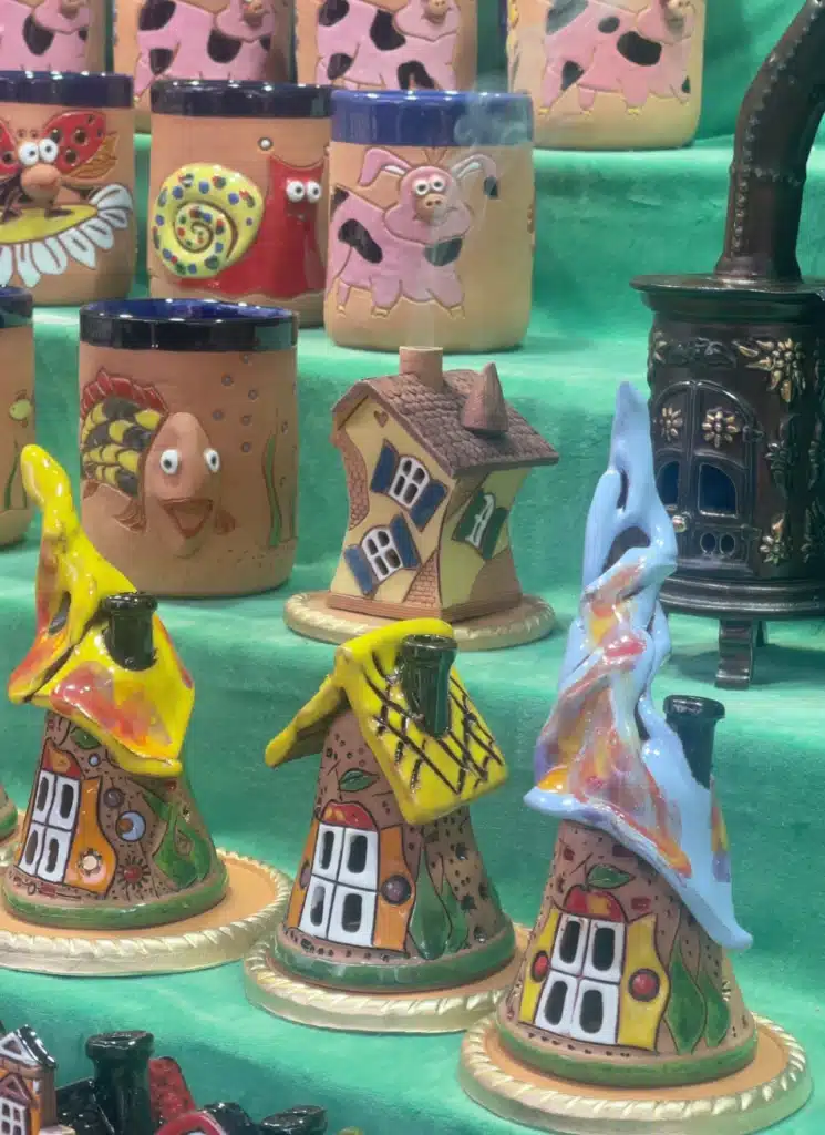 Hand-painted ceramic mugs and incense houses for sale at Bregenz Christmas market