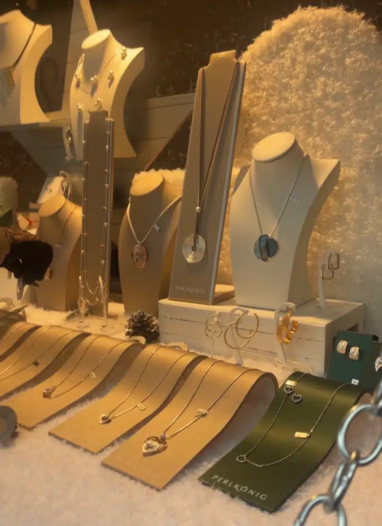 Silver and gold jewelry display at Perlkönig stall, Bregenz Christmas market