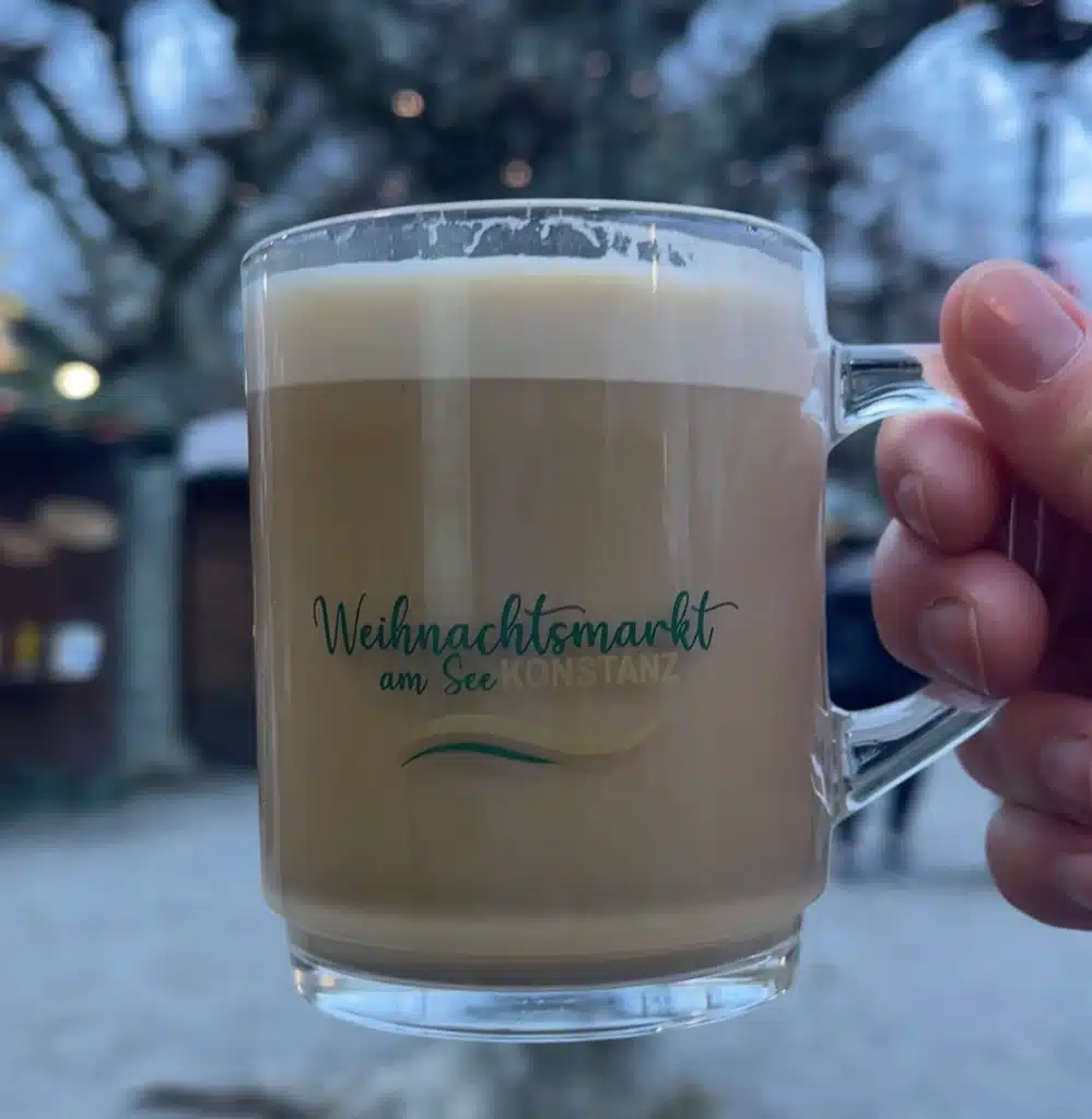 Hand holding branded latte mug from Weihnachtsmarkt am See Konstanz