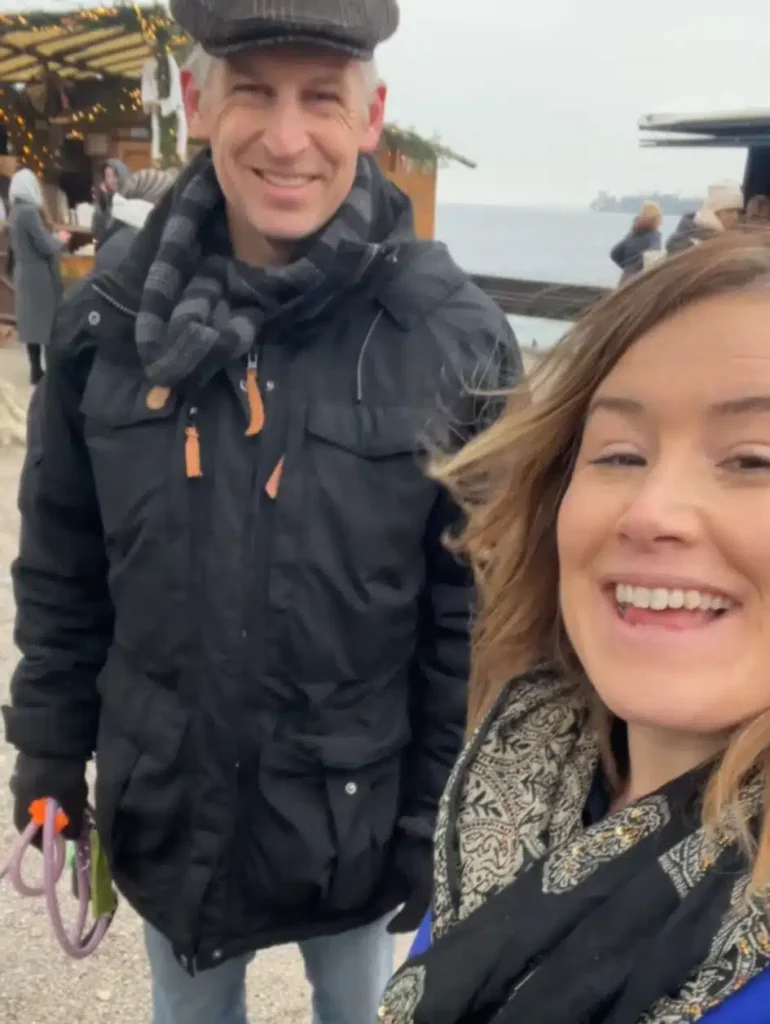 Couple smiling at Konstanz Christmas Market am See with Lake Constance in the background