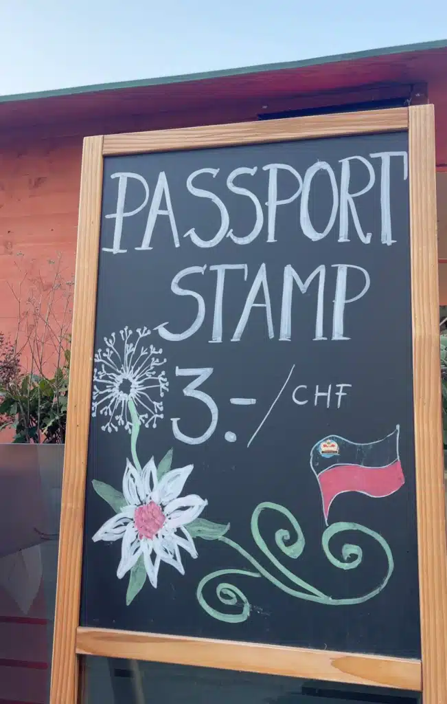 Hand-painted passport stamp sign advertising 3 CHF stamps with Liechtenstein flag