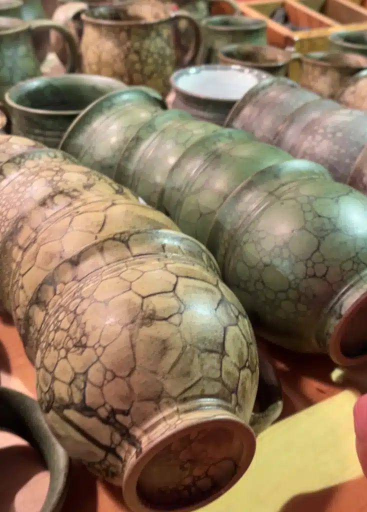 Handmade bubble-glaze pottery mugs and vases at a craft stall at the Lindau Christmas market