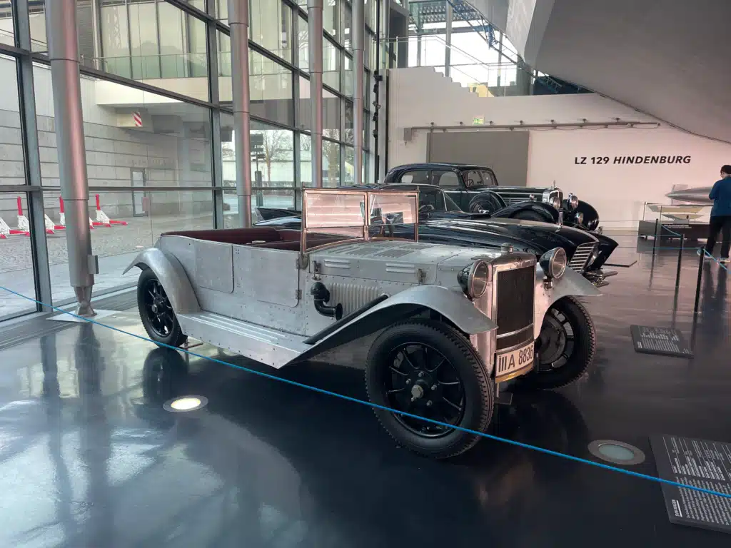 Vintage open-top Maybach car on display near LZ 129 Hindenburg exhibit at Zeppelin Museum