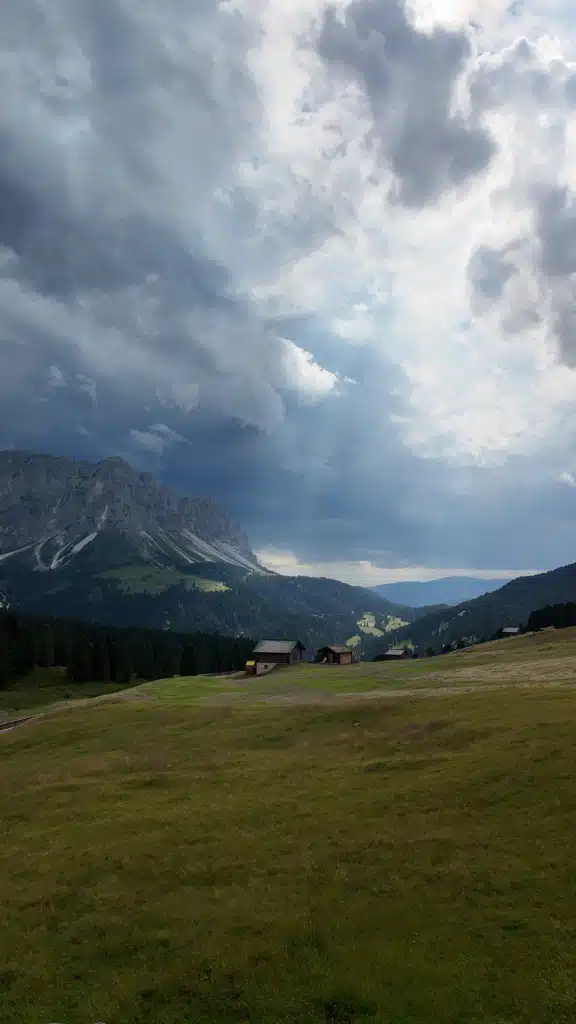 Storm clouds rolling over the Dolomites valley, view from a room balcony at Ütia de Börz, Passo delle Erbe