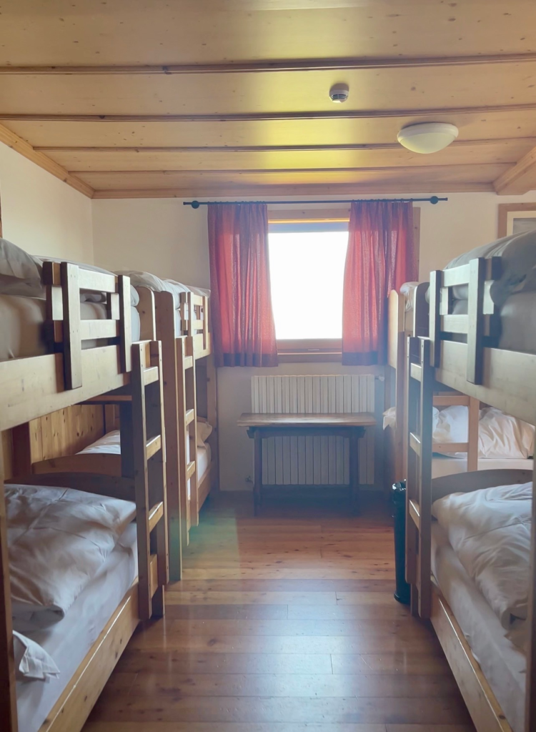 Wooden bunk beds in a shared dormitory room at Rifugio Lagazuoi