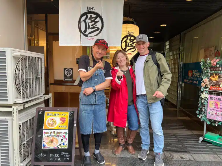 Chef Shu with two guests outside Menya Shu ramen shop in Tennoji after an Osaka ramen cooking class