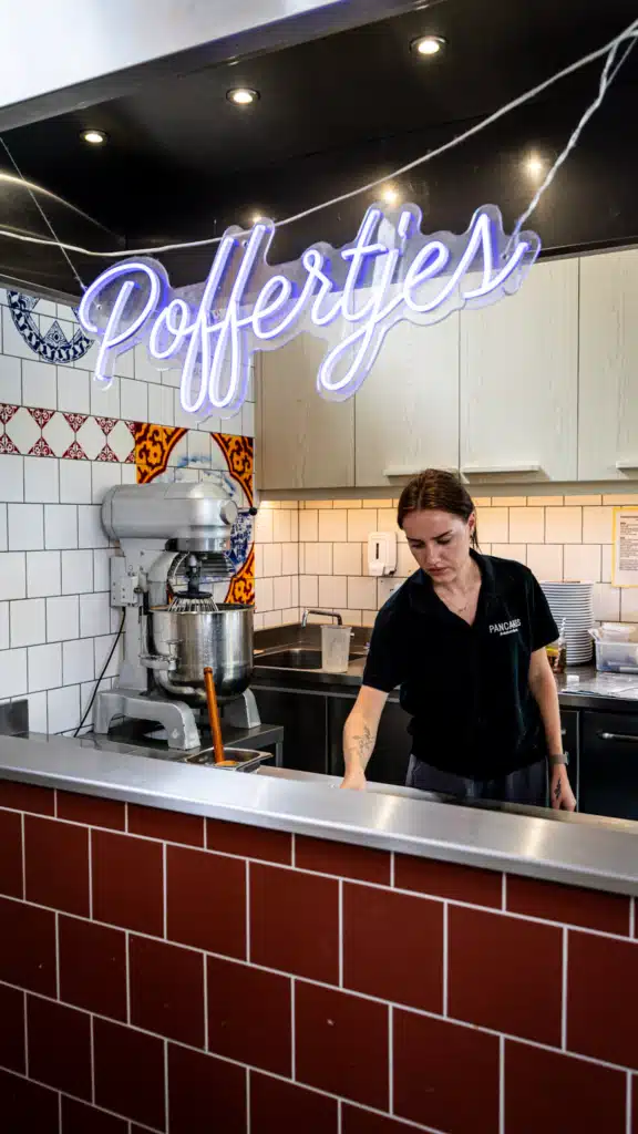 Neon Poffertjes sign above the kitchen at Pancakes Amsterdam in the Jordaan