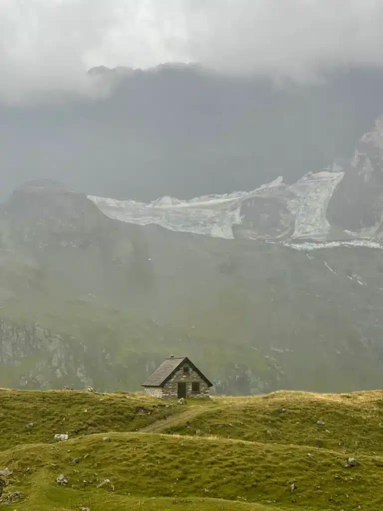 Stone shepherd's hut below a glacier near Refuge de la Glière on the climb to Col du Palet, Tour du Vallaisonnay in Vanoise National Park