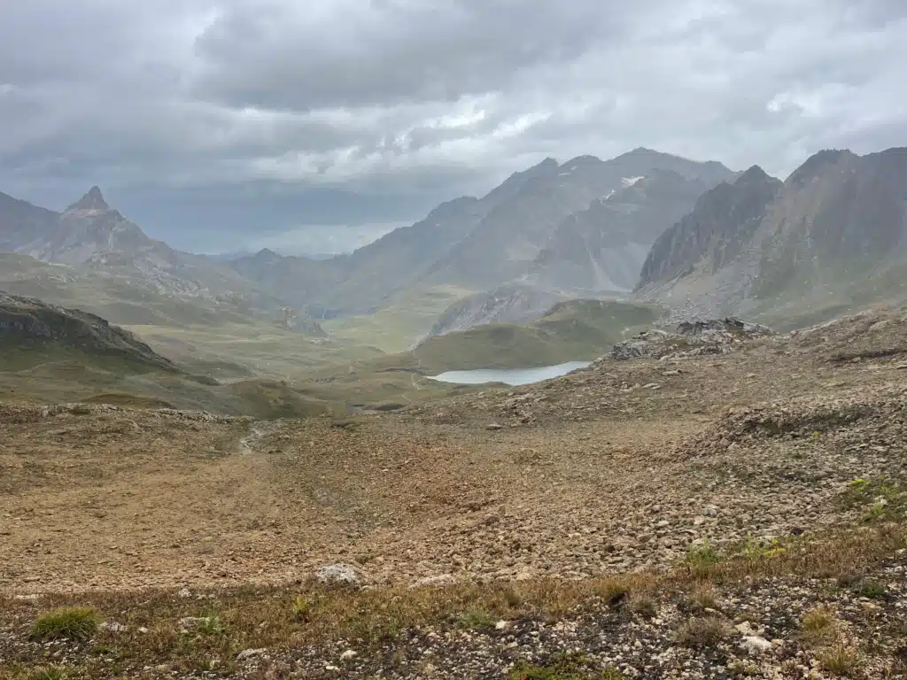 View from the top of Col du Palet with storm clouds over the Vanoise peaks on day 4 of the Tour du Vallaisonnay