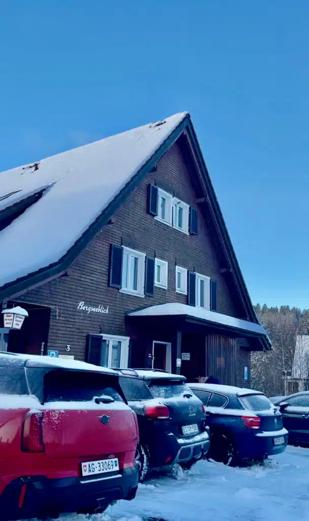 the facade of a hotel with the words bergseeblick on the front in the Titisee, Black Forest of Germany