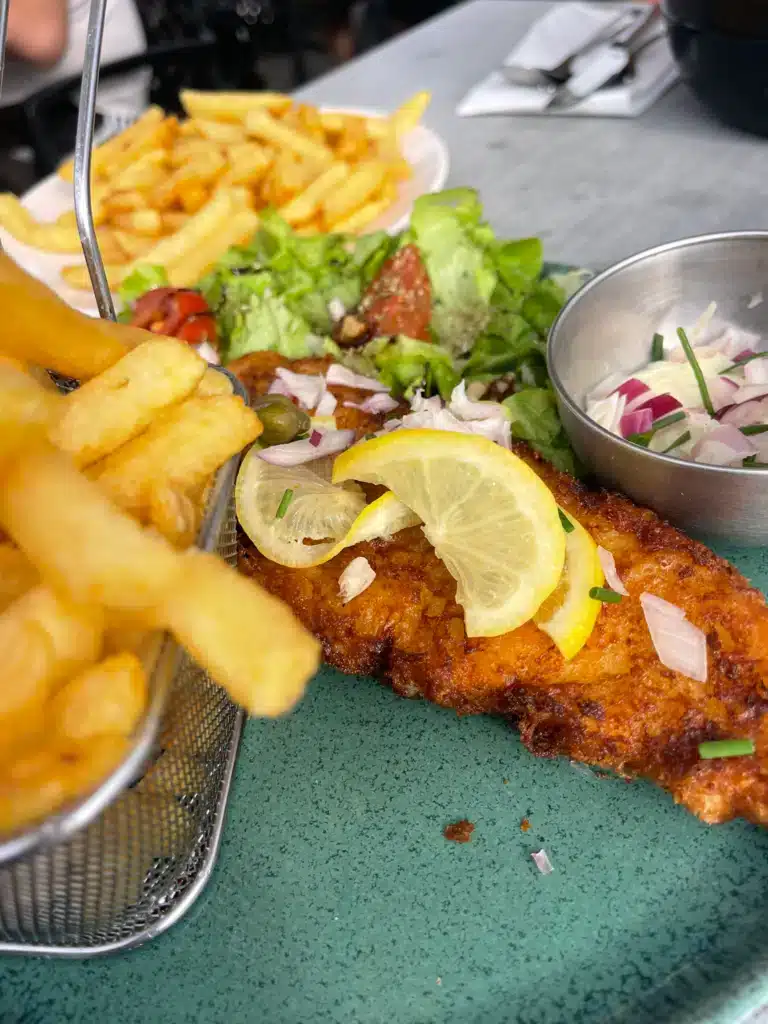 Fish and chips Fried fish fillet with lemon, fries and salad at La Table d'Augustine, a dinner option in Wissant