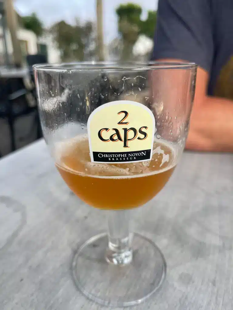 2 Caps beer Glass of 2 Caps beer, brewed locally near Wissant by Christophe Noyon, on a terrace table in the village