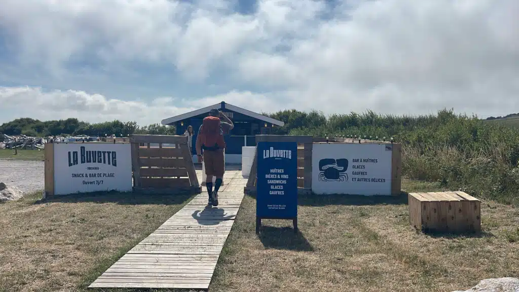 La Buvette Hiker walking into La Buvette, a seasonal beach snack bar in Tardinghen serving oysters, beer and waffles