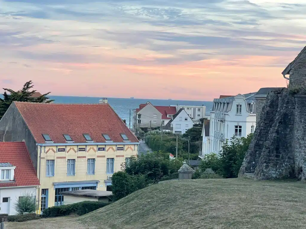 Sunset over Ambleteuse with the old Hôtel Restaurant Café Pension building, seaside villas and the Channel beyond