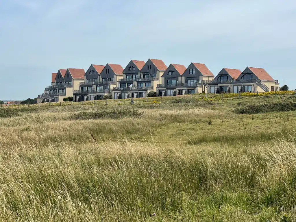 Holiday apartments above the dunes Row of gabled holiday apartments with balconies above the dunes on the coastal path approaching Wimereux